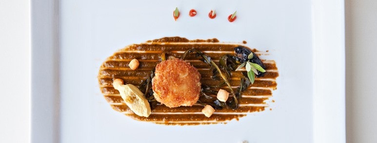  A chef is decorating a dish