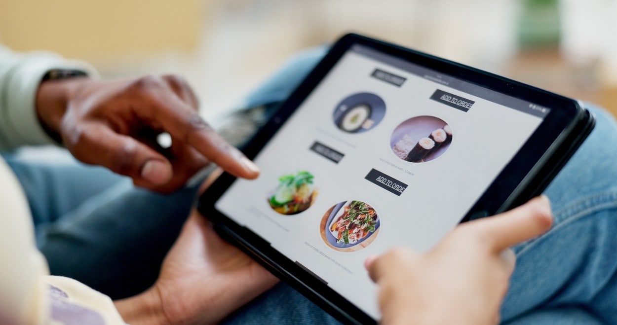 Hands, tablet and food delivery with screen for online shopping in home, scroll and couple in lounge. People, tech and ui display with ecommerce, order or digital menu for meal with app at apartment