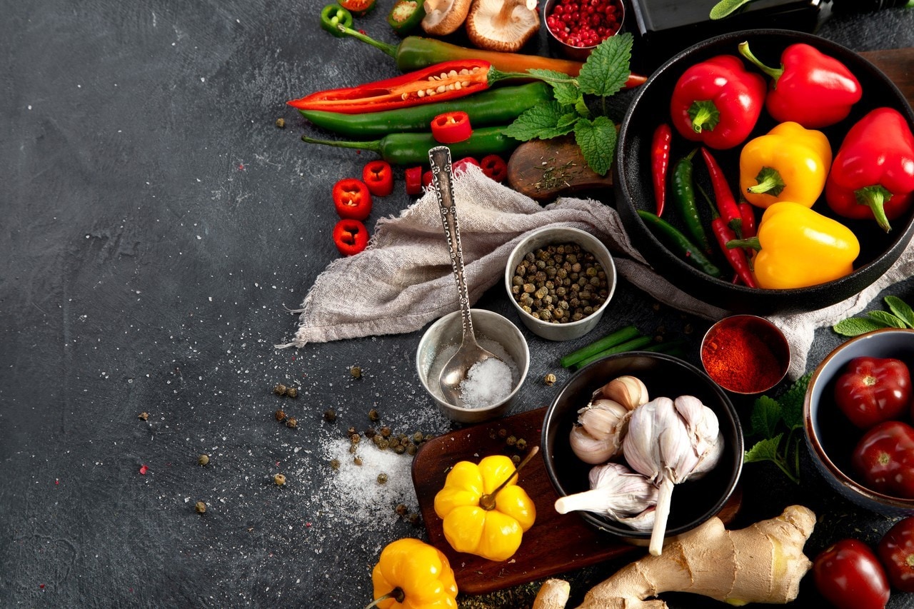 Spices , peppers, garlik, tomatos, mushrooms on dark background. Ingredient for cooking. Top view, copy space