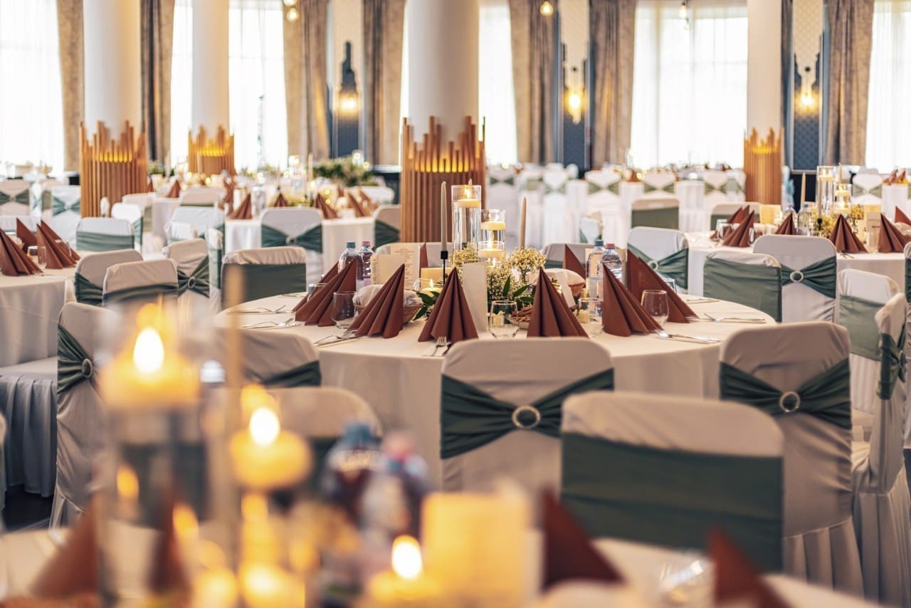 Decorated tables and modern lighting in a banquet hall for wedding