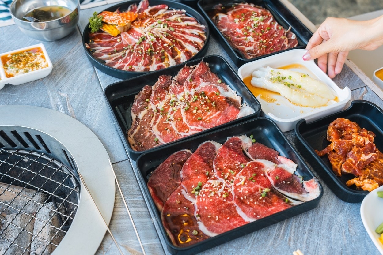 Assorted various type of premium meats including marbled beef, seafood prepared for charcoal grill dining at barbecue restaurant