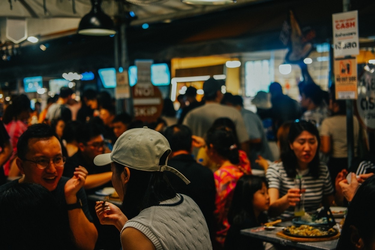 Bangkok, Thailand - April 10 2024: Busy Street Food Market Filled with Happy Diners Enjoying Local Cuisine