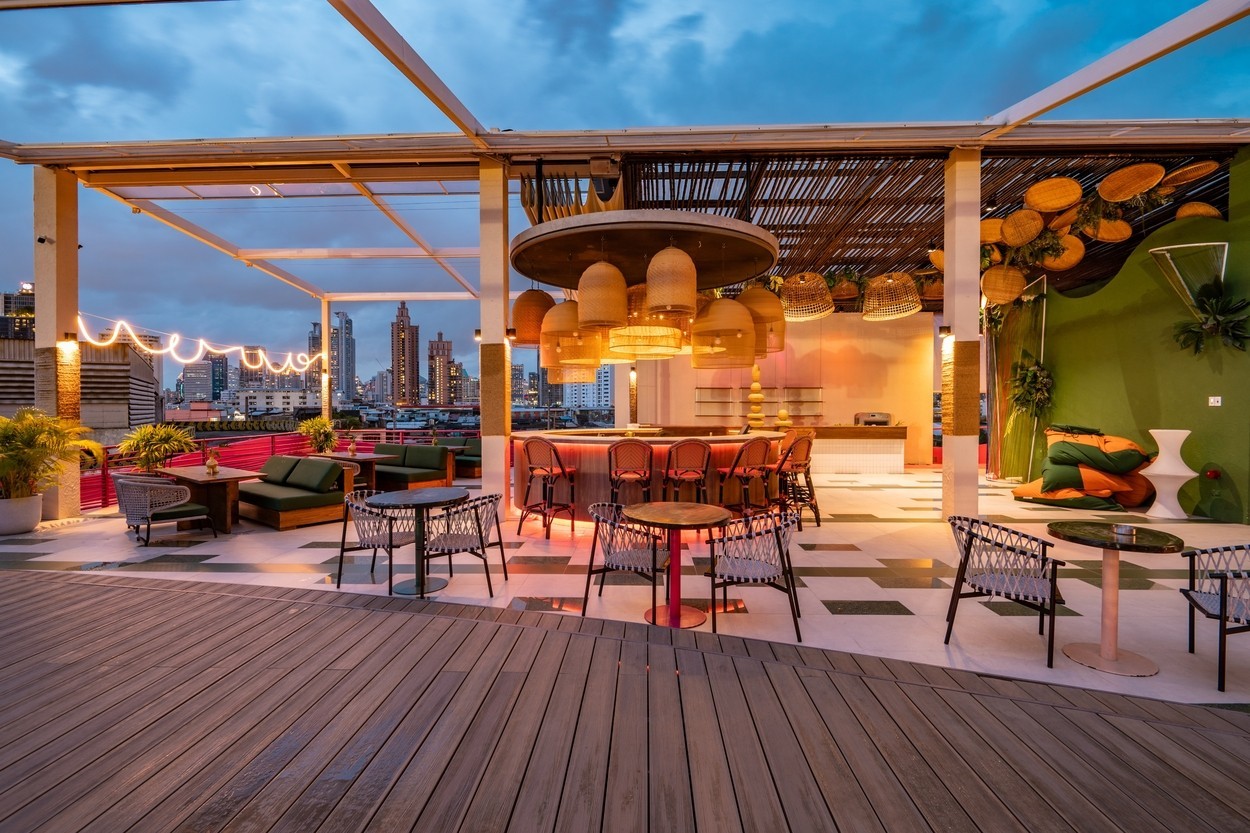 Contemporary roof top bar and cityscape view at twilight.
