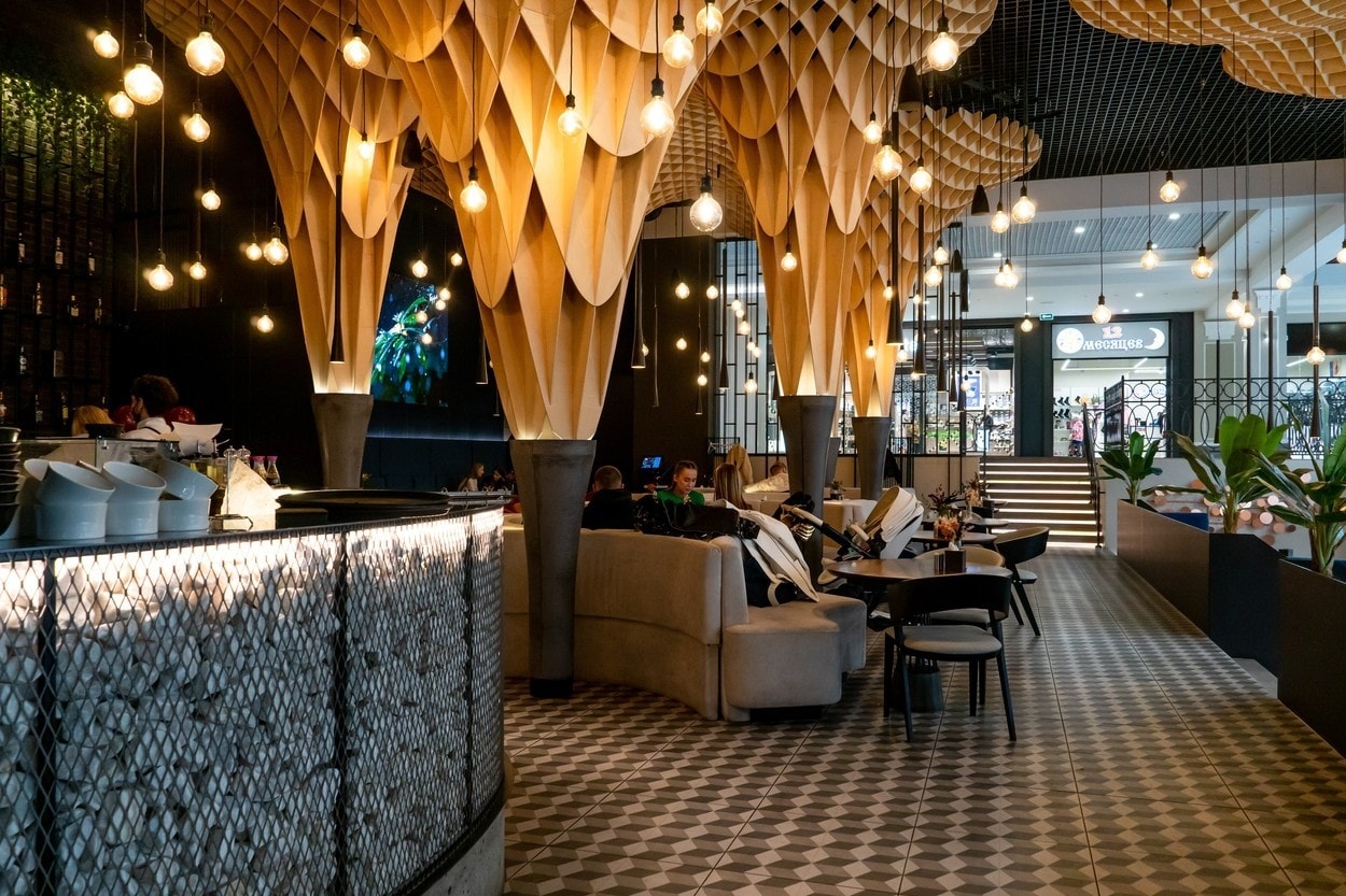 Belarus, Grodno, June 12, 2022: Modern and stylish coffee shop design. The interior of the restaurant with tables and chairs and a copy space.