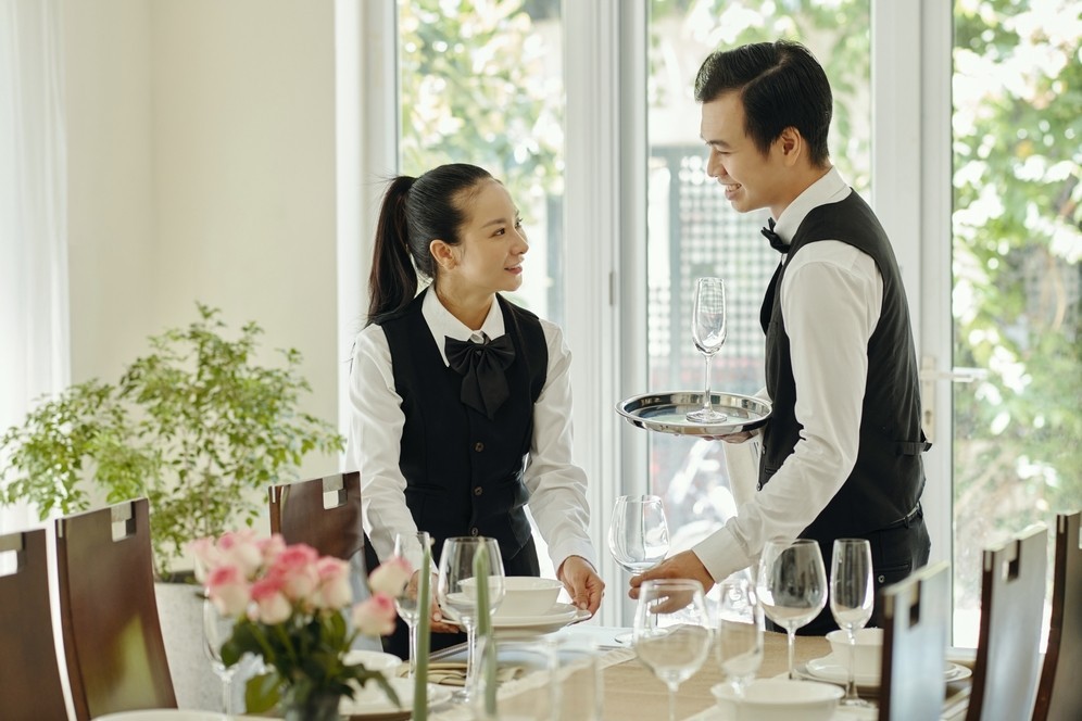 Waiters Setting The Dining Table
